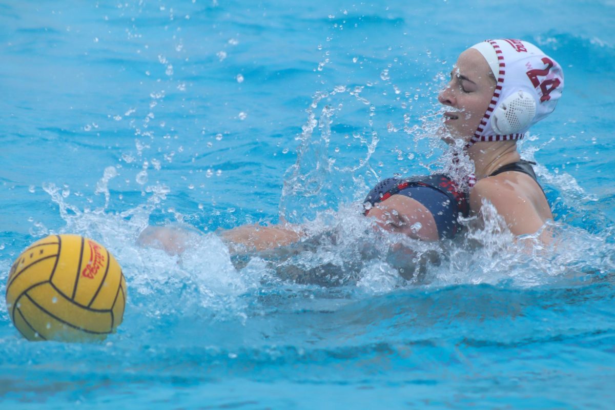 A Hoosier defender dunks Bulldogs' attacker Hailey Andress below the water as she loses the ball at the Fresno State Aquatics Center. Andress broke Brooke Ochoa's all-time scoring record against the Cal Lutheran Regals.