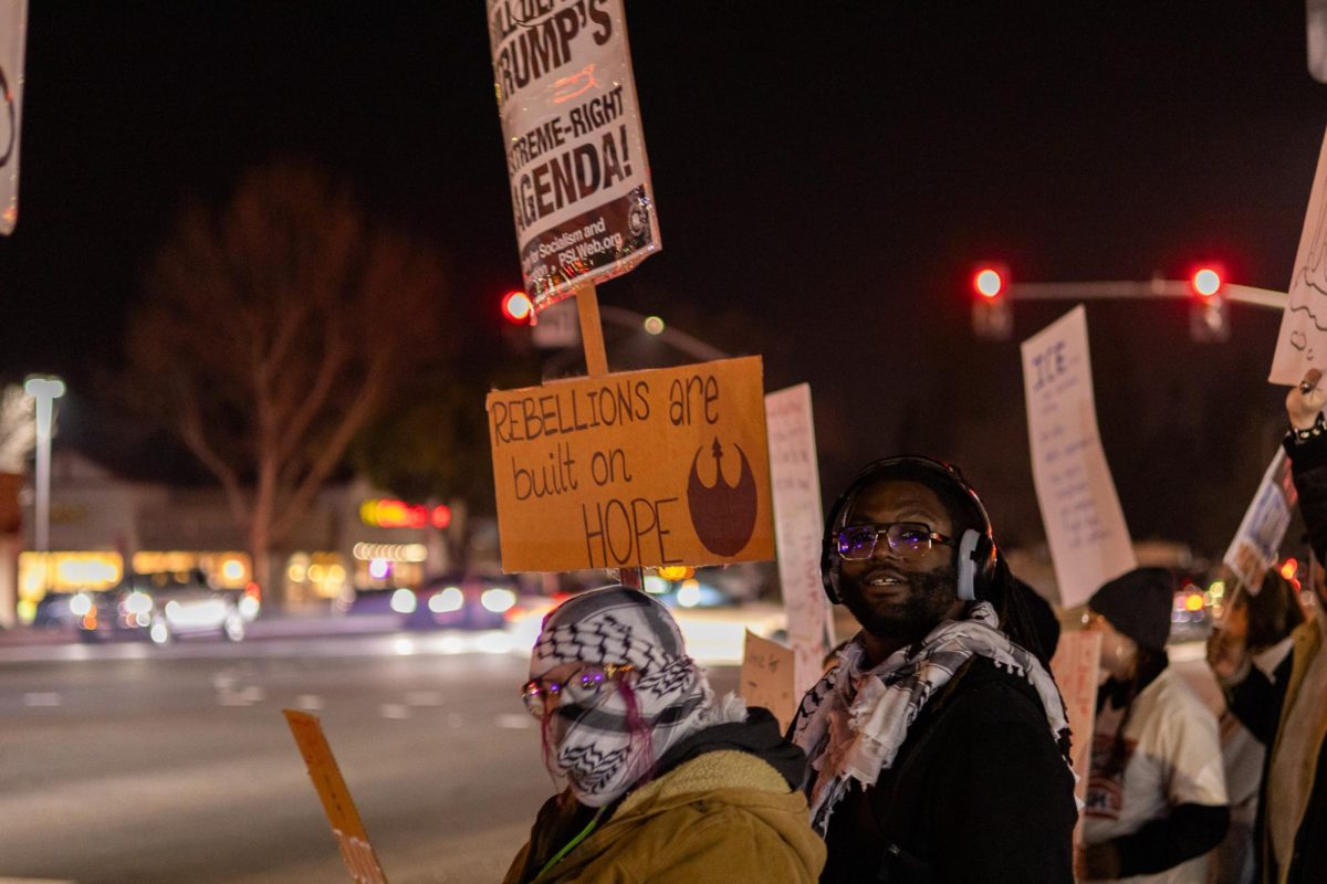 A man holds up a sign with the message "rebellions are built on hope" with the resistance logo from "Star Wars" on Jan. 25.