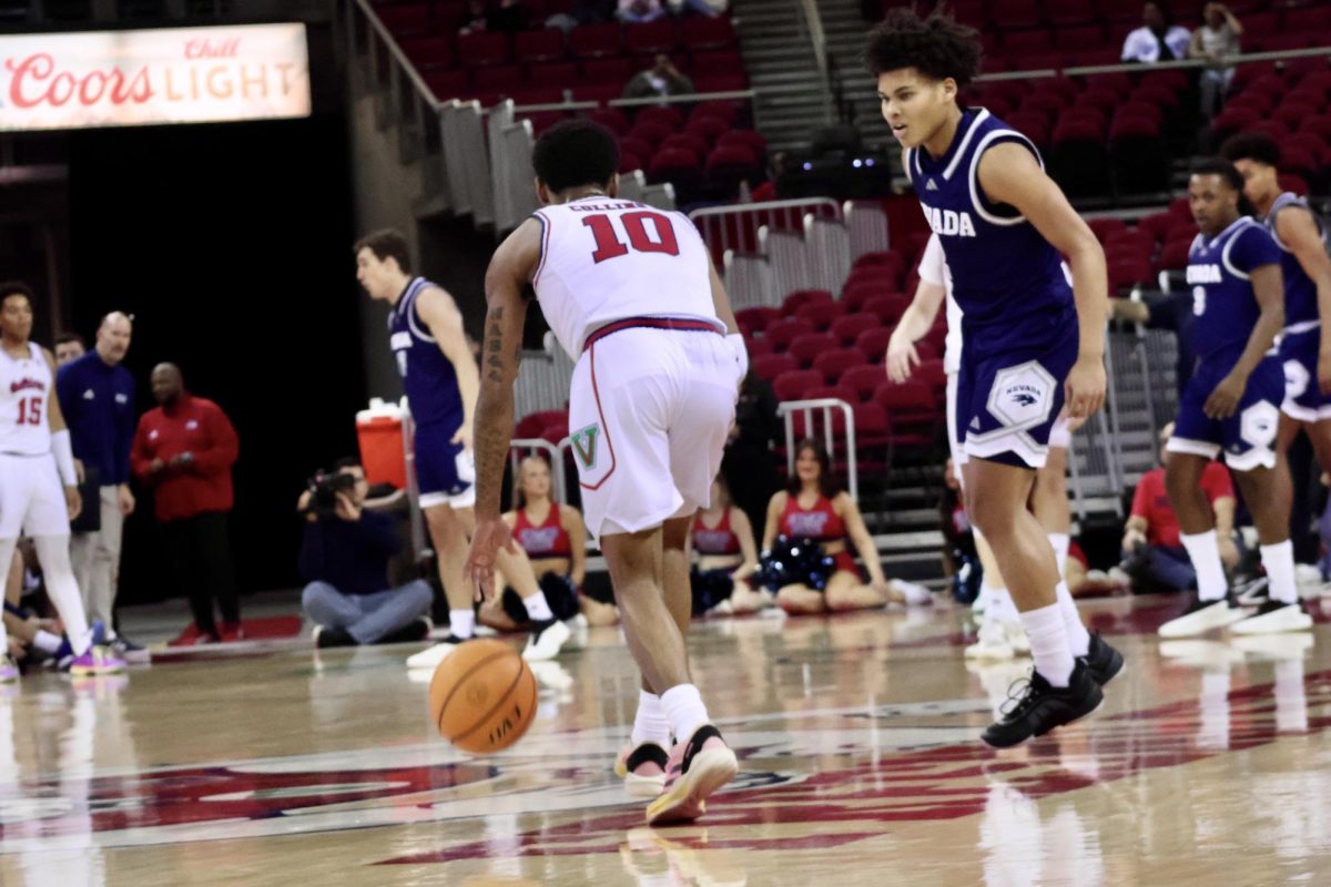 Guard Zaon Collins dribbles the ball up the floor.