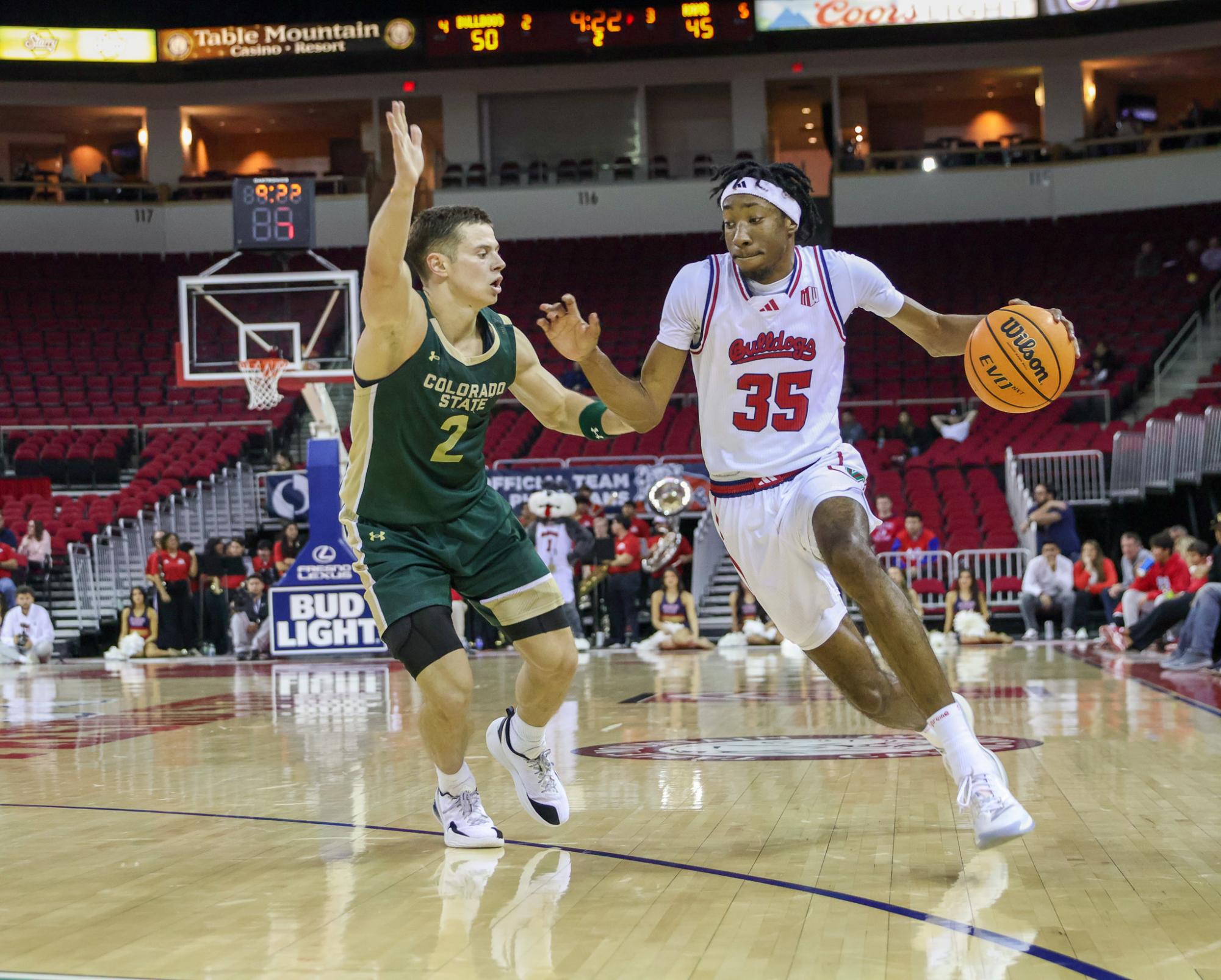 Bulldogs' forward DeShawn Gory (35) drives past Brandon Rechsteiner (2), attempting to block him as the clock ticks down into the final stretch of the game. 
