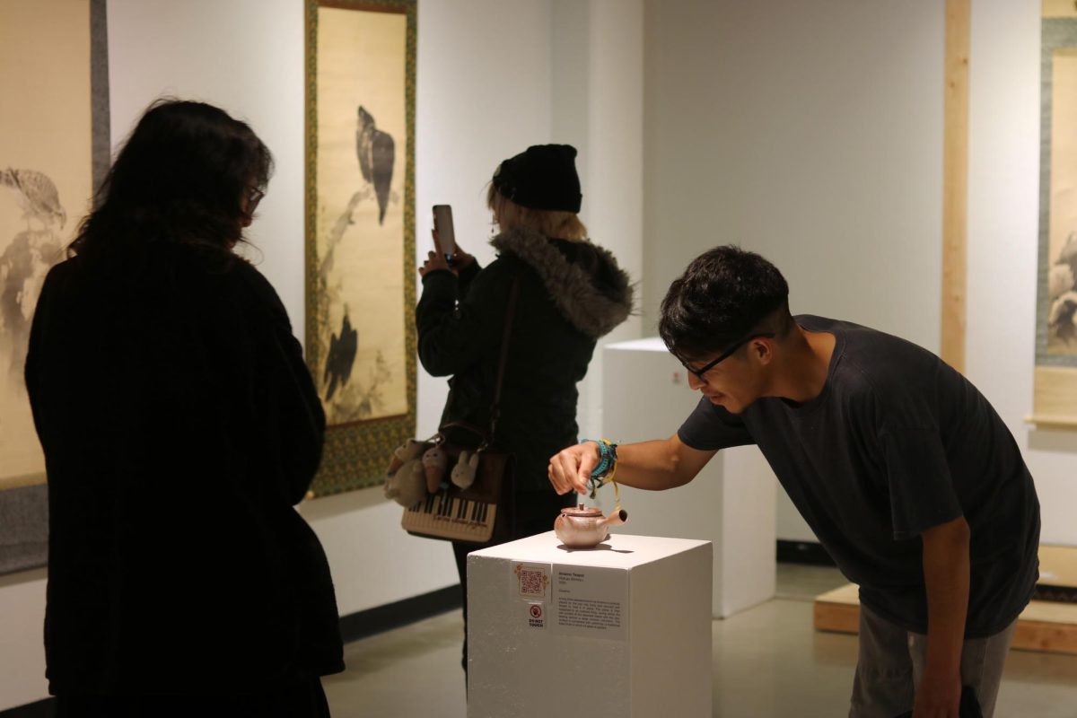 Launch party attendees observe art in the Phebe Conley Art Gallery on Jan. 22.