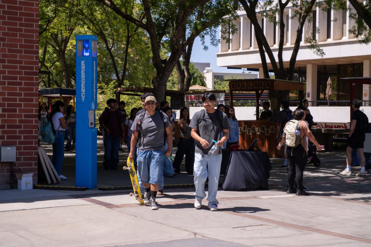 Students walking in front of the Kennel Bookstore. 