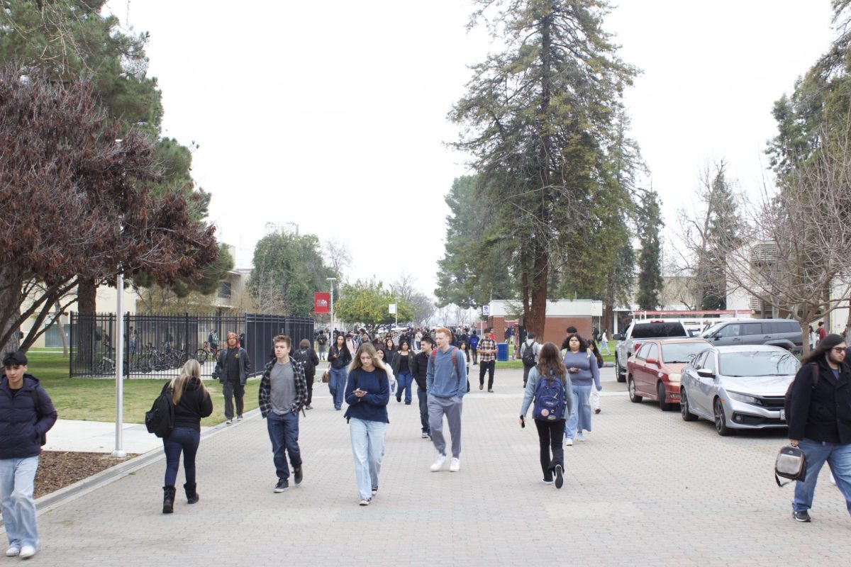 Students walking in front of the library. 