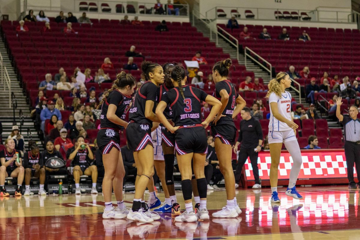 The Fresno State women's basketball team huddles in the paint during a break in the action against the Boise State Broncos on Feb. 11 at the Save Mart Center.
