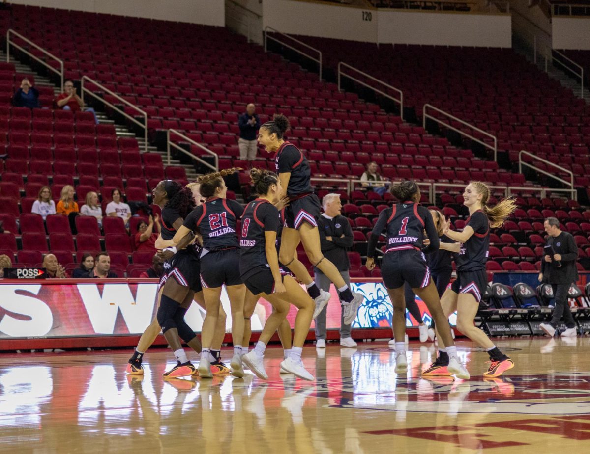The Fresno State women's basketball team celebrates at midcourt after the final buzzer on Feb. 11 at the Save Mart Center. The Bulldogs snapped the Broncos' nine-game winning streak with a 75-69 victory.