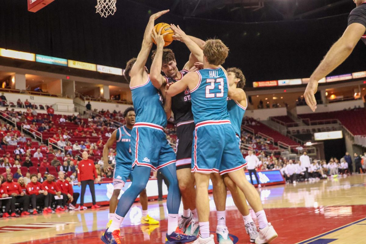 Fresno State men's basketball center Wilson Jacques fights for an offensive rebound against three New Mexico Lobo defenders on Feb. 21 at the Save Mart Center. Despite leading by 22, the 'Dogs lost a crucial Mountain West matchup 80-78.