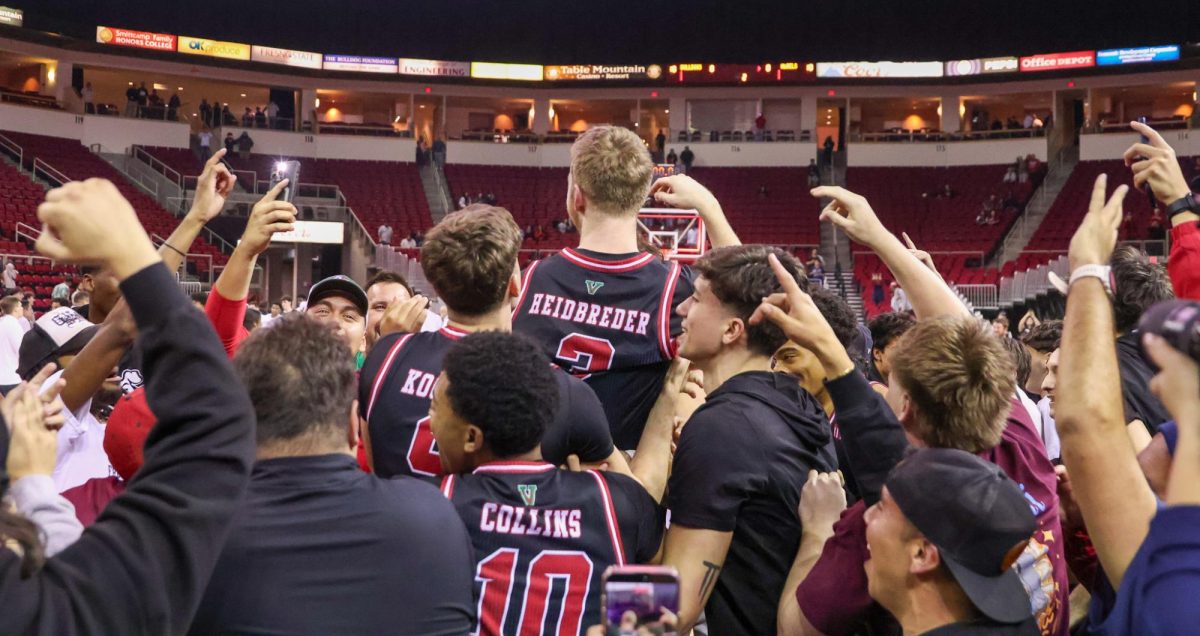 Fresno State men's basketball guard Jake Heidbreder is mobbed by his teammates and fans after hitting a buzzer-beater to defeat the UNLV Rebels 98-96 on Feb. 3 at the Save Mart Center.