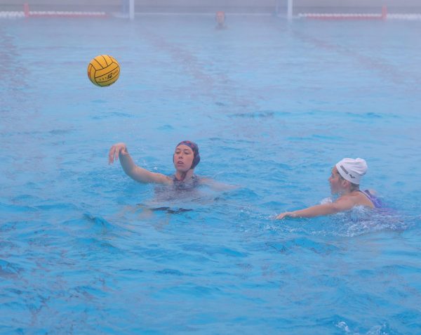 Hailey Andress passes down to a teammate against a capless Spartan defender.