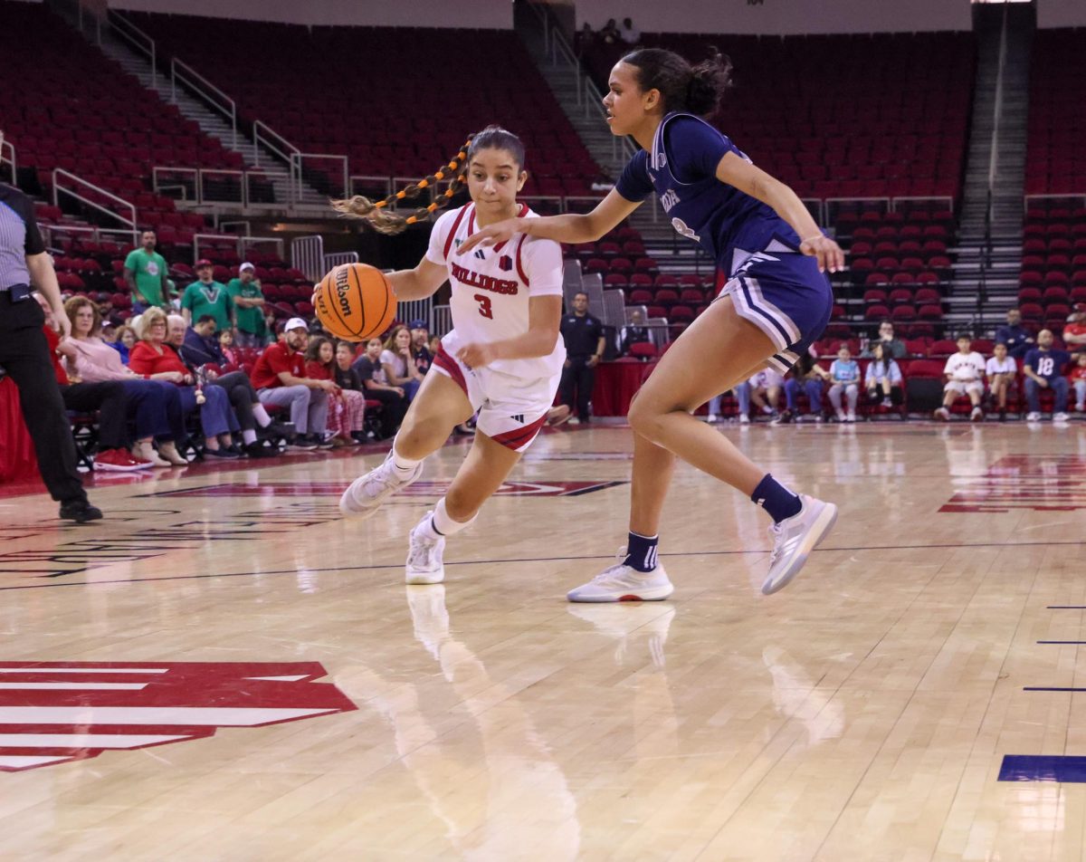 Fresno State women's basketball guard Danae Powell drives on a UNR Wolf Pack defender on Feb. 7 at the Save Mart Center.