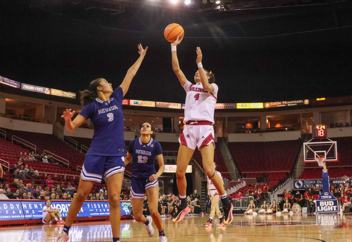 Fresno State women's basketball forward Jaisa Gamble elevates for a one-handed floater over a Wolf Pack defender on Feb. 7 at the Save Mart Center. Gamble finished the afternoon with 15 points on 7-of-8 shooting.