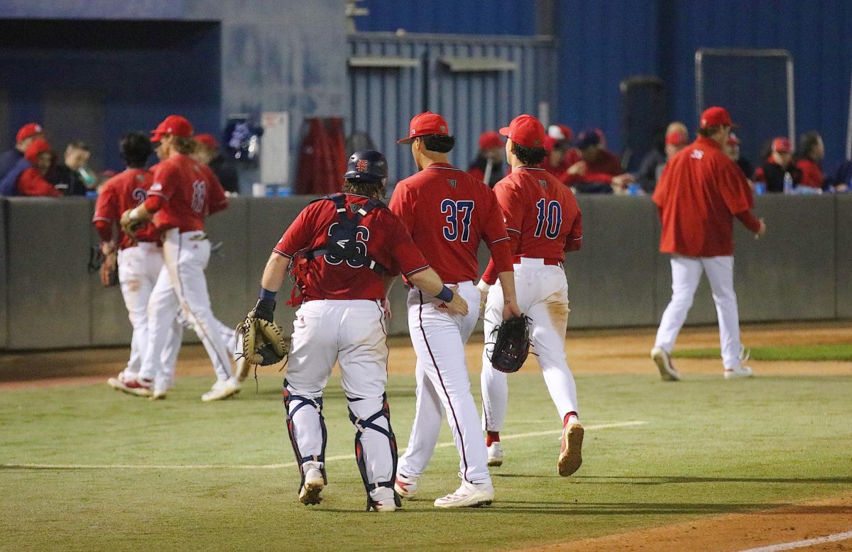 Fresno State baseball catcher Austin Young (36) and pitcher Moose Cuellar (37) walk off the field after an inning of work on Feb. 13 at Bob Bennett Stadium. Cuellar's Diamond 'Dog debut saw him come in relief of pitcher Drew Townson in the third inning with the bases loaded.