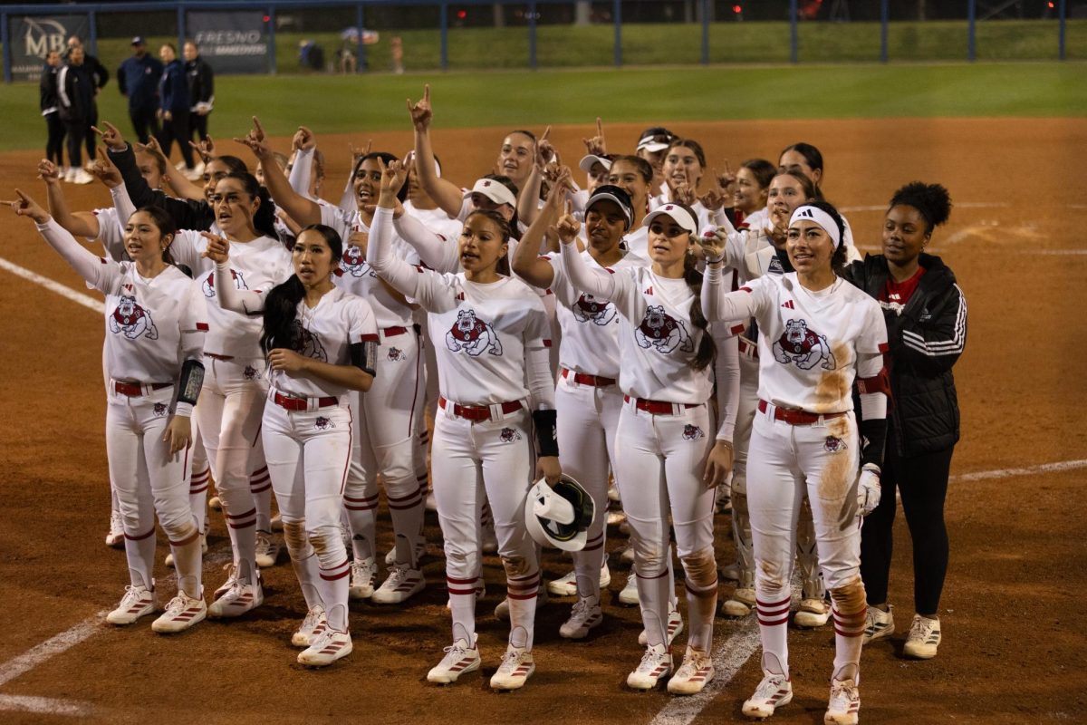 The Fresno State softball team celebrates around home plate at Margie Wright Diamond by singing the fight song.