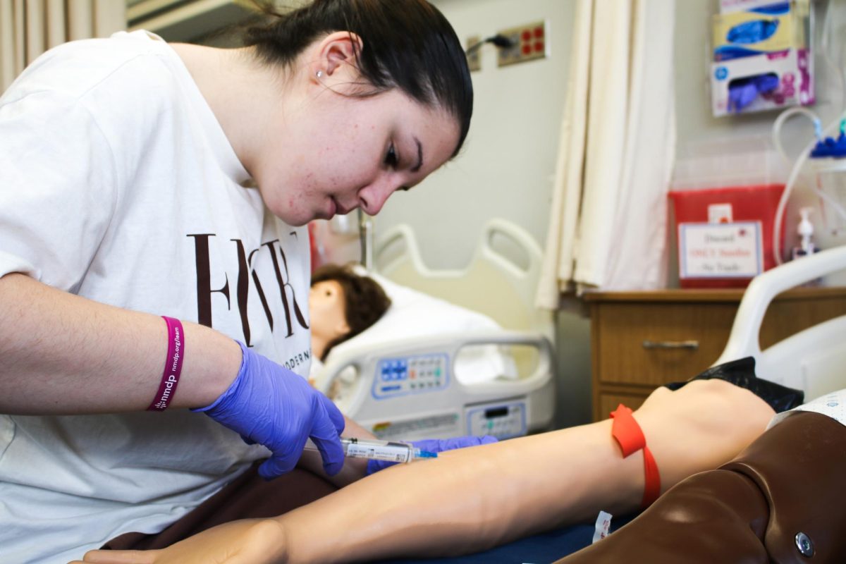 Emma Hadzi-Kimov practices inserting an IV.