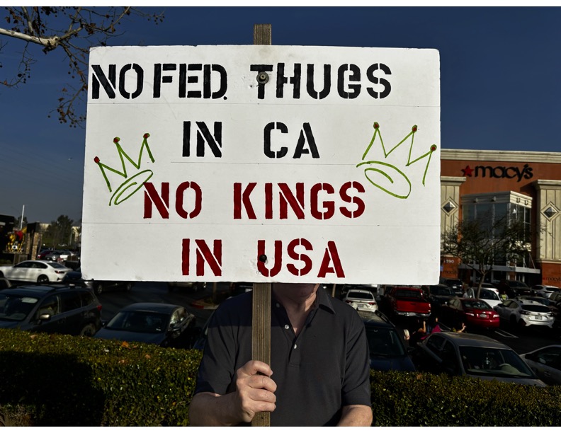 Protester holds a sign at the "Disappeared in America" protest which happened outside of the River park shopping center on Jan. 31. 