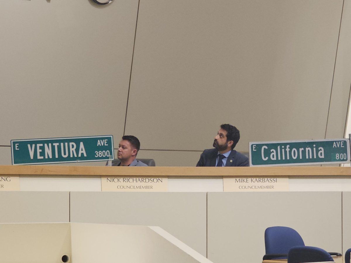 Fresno City Councilmen Nick Richardson and Mike Karbassi pose with new street signs during a Fresno City Council meeting in Fresno, on March 19.

