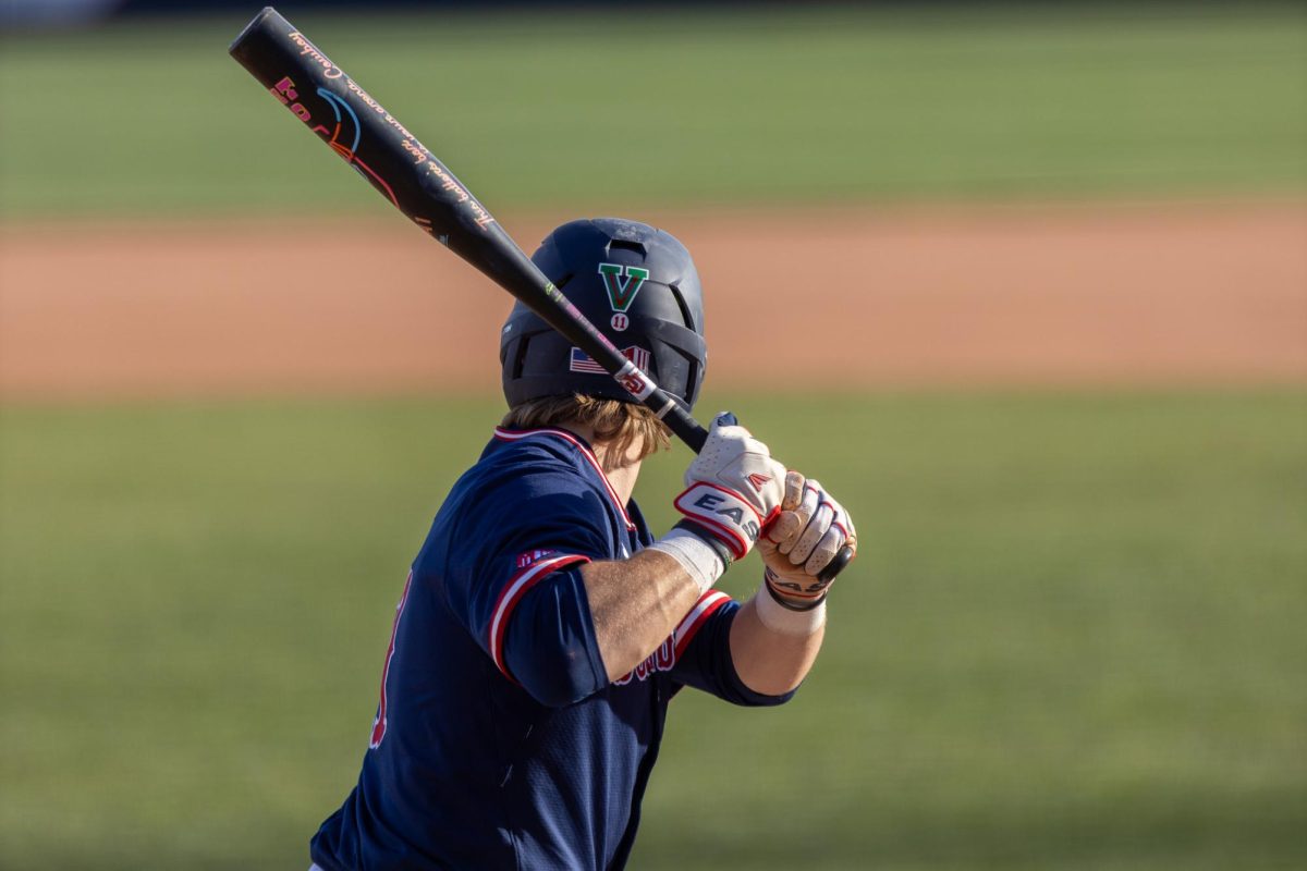 A Diamond 'Dog anticipates an incoming pitch on Feb. 15 at Bob Bennett Stadium.