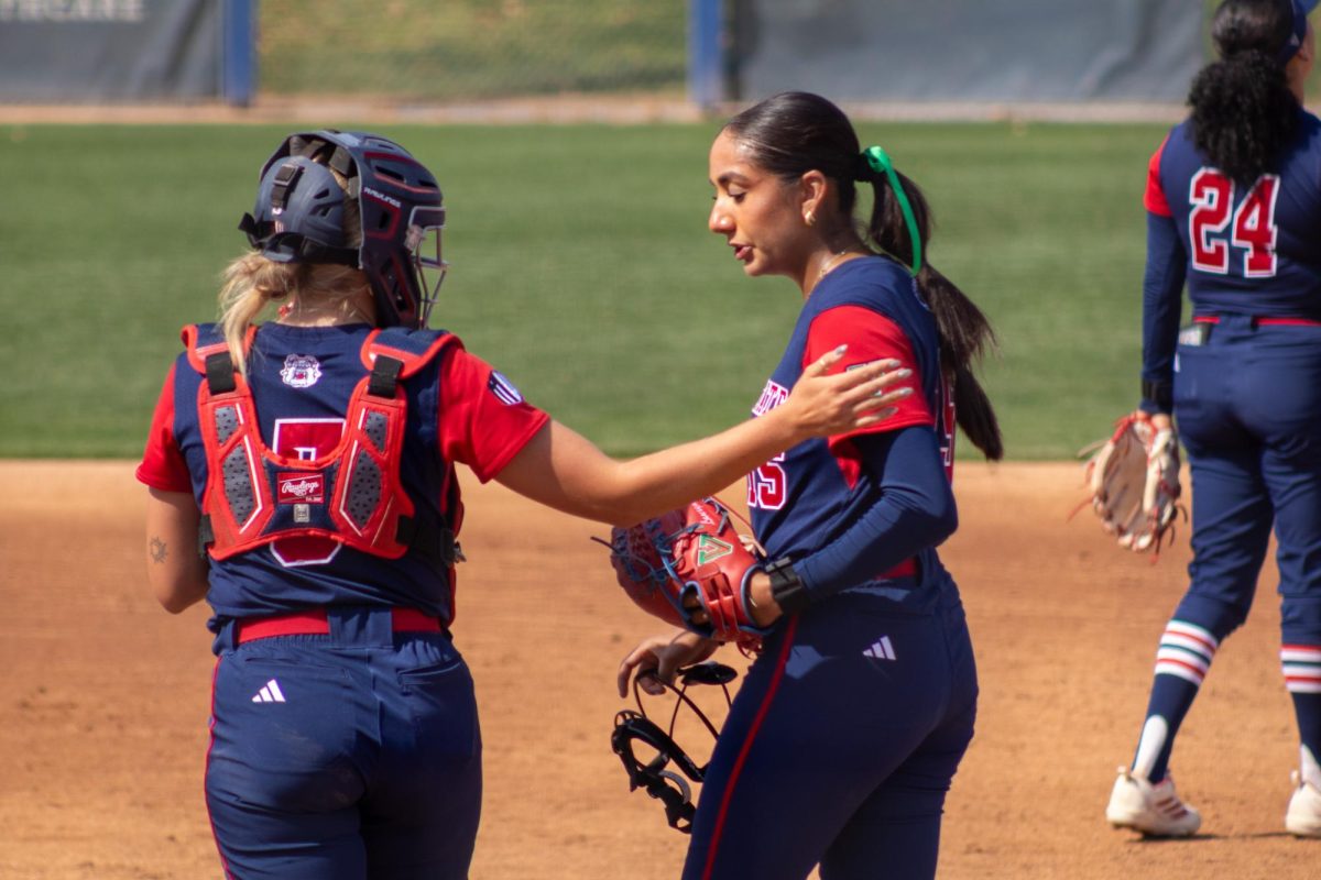 Fresno State softball catcher Rylee Bocchini taps pitcher Lauryn Carranco on the shoulder after a mound visit on March 15 at Margie Wright Diamond. Carranco propelled the Bulldogs to 6-2 victory with a dominant pitching performance.