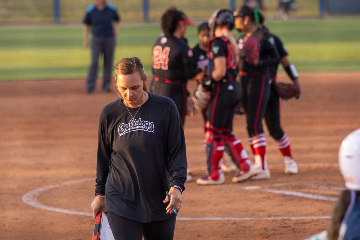 Bulldogs' head coach Charlotte Morgan walks back to the dugout after a mound visit during the top of the third inning. 