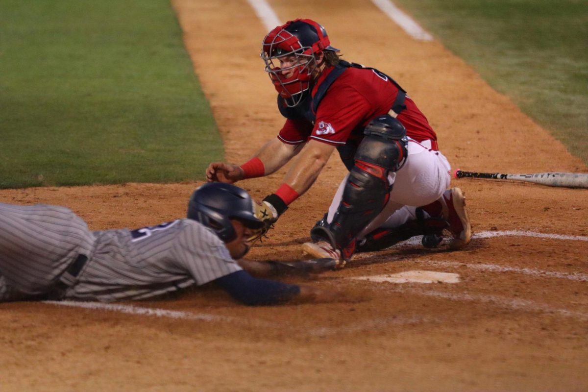 Fresno State catcher Austin Young tries to tag a Wolf Pack runner at home plate in the top of the fourth inning. 