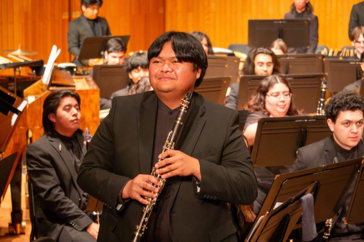 Jason Hilario stands to be recognized after a clarinet solo in the second piece of the night.