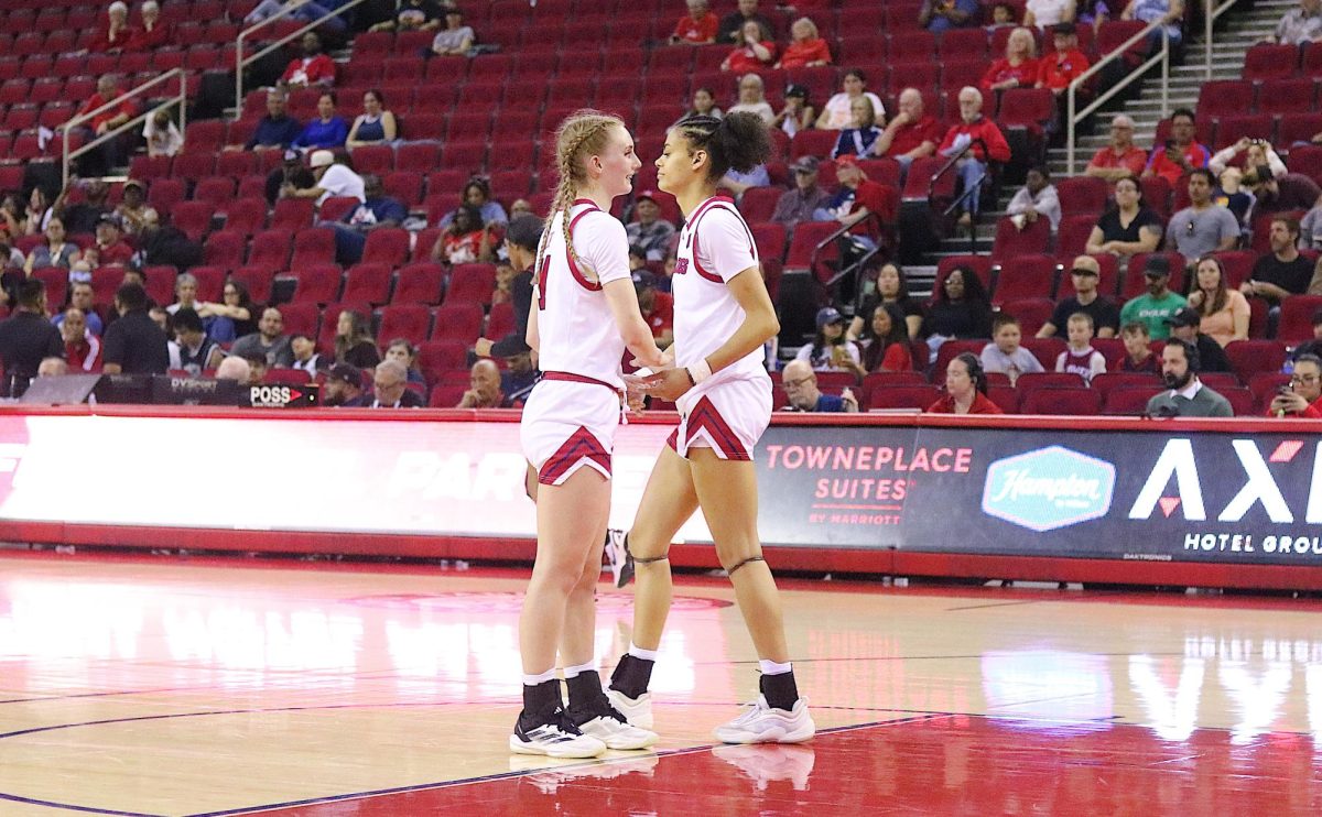 Fresno State women's basketball guard Emilia Long and forward Jaisa Gamble tap hands at the free-throw line during a break in the action on Feb. 28 at the Save Mart Center.