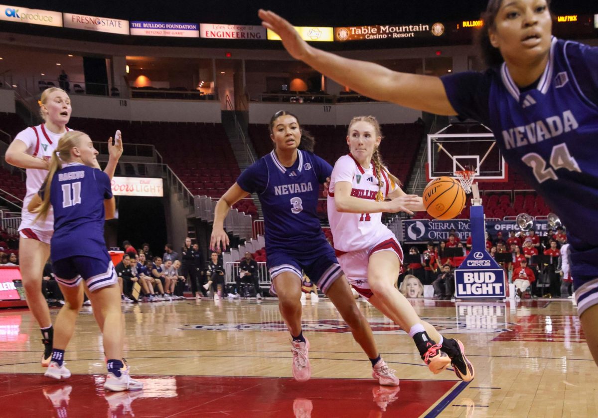 Fresno State women's basketball guard Emilia Long drives to her left on a University of Nevada, Reno Wolf Pack defender on Feb. 7 at the Save Mart Center. Long was named as an All-Mountain West Honorable Mention on March 7 ahead of the Mountain West Tournament