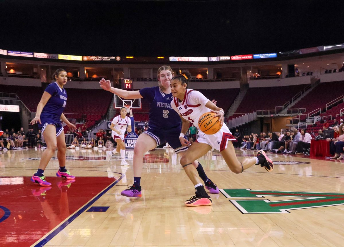 Fresno State women's basketball forward Jaisa Gamble drives on a Nevada Wolf Pack defender on Feb. 7 at the Save Mart Center. Gamble and the 'Dogs will face the Wolf Pack in the first round of the Mountain West Tournament on March 7 in Las Vegas.