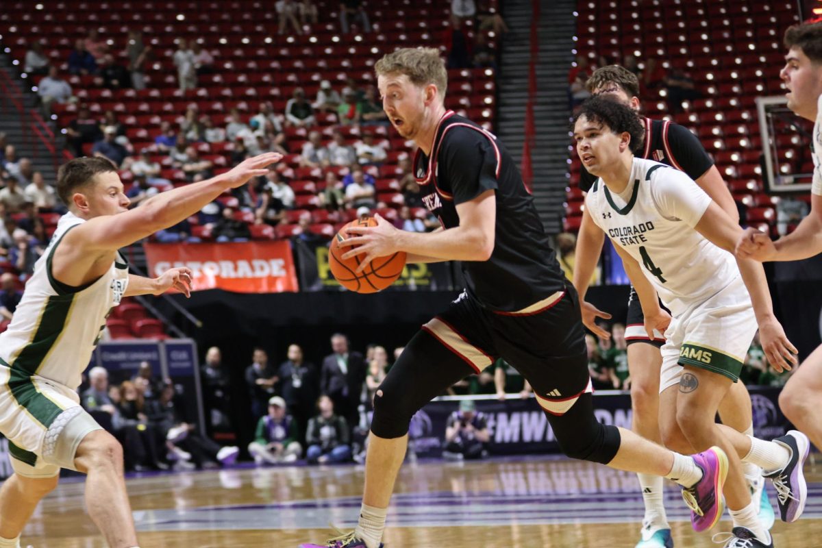 Jake Heidbreder drives through Rams defenders to finish a layup at the rim.