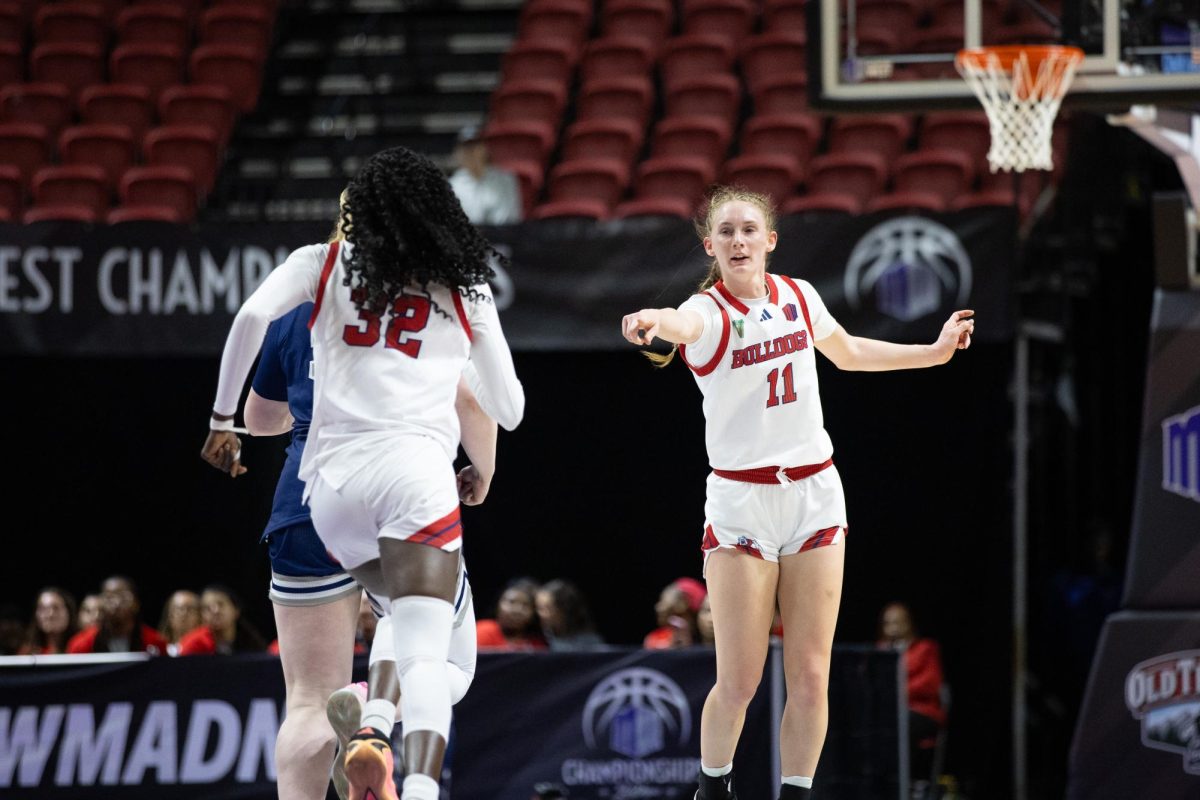 Emilia Long points at teammate Djessira Diawara after a successful offensive possession.