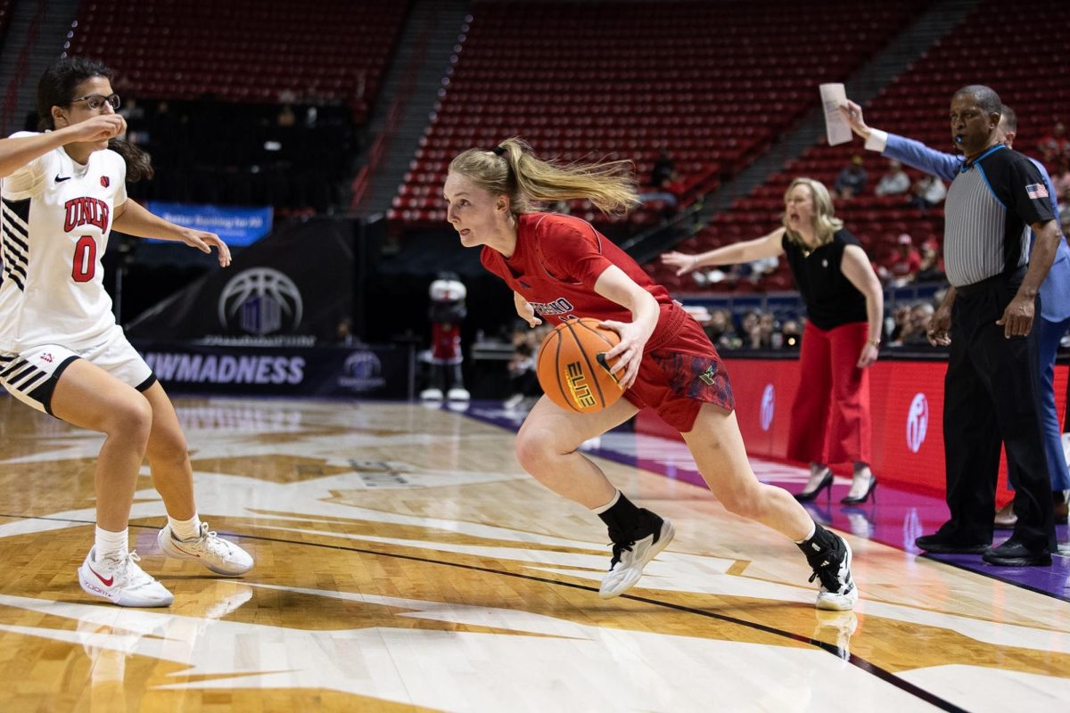 Emilia Long dribbles right.