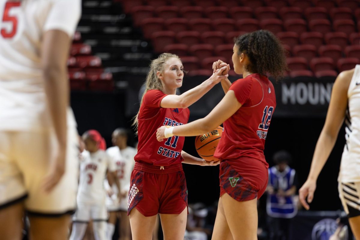 Fresno State women's basketball guard Emilia Long and forward Avery Watkins embrace hands as their quarterfinal match of the Mountain West Tournament against the University of Nevada, Las Vegas ends on March 8. Watkins and Long led the Bulldogs' offensive effort with 19 and 16 points.