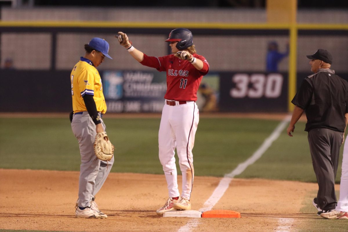 Brady Hewitt celebrates a single that resulted in a run.