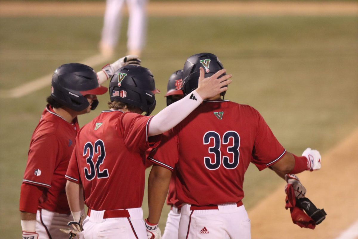 Players greet Sky Collins at home plate after he blasts a home run in the seventh inning against the Bakersfield Roadrunners on April 14 at Bob Bennett Stadium.