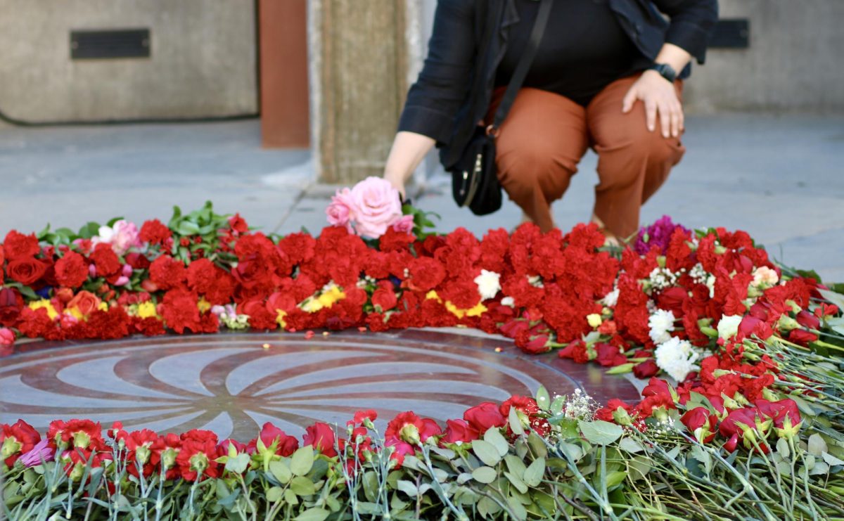 A woman lays flowers in the heart of the Armenian Genocide Monument. 