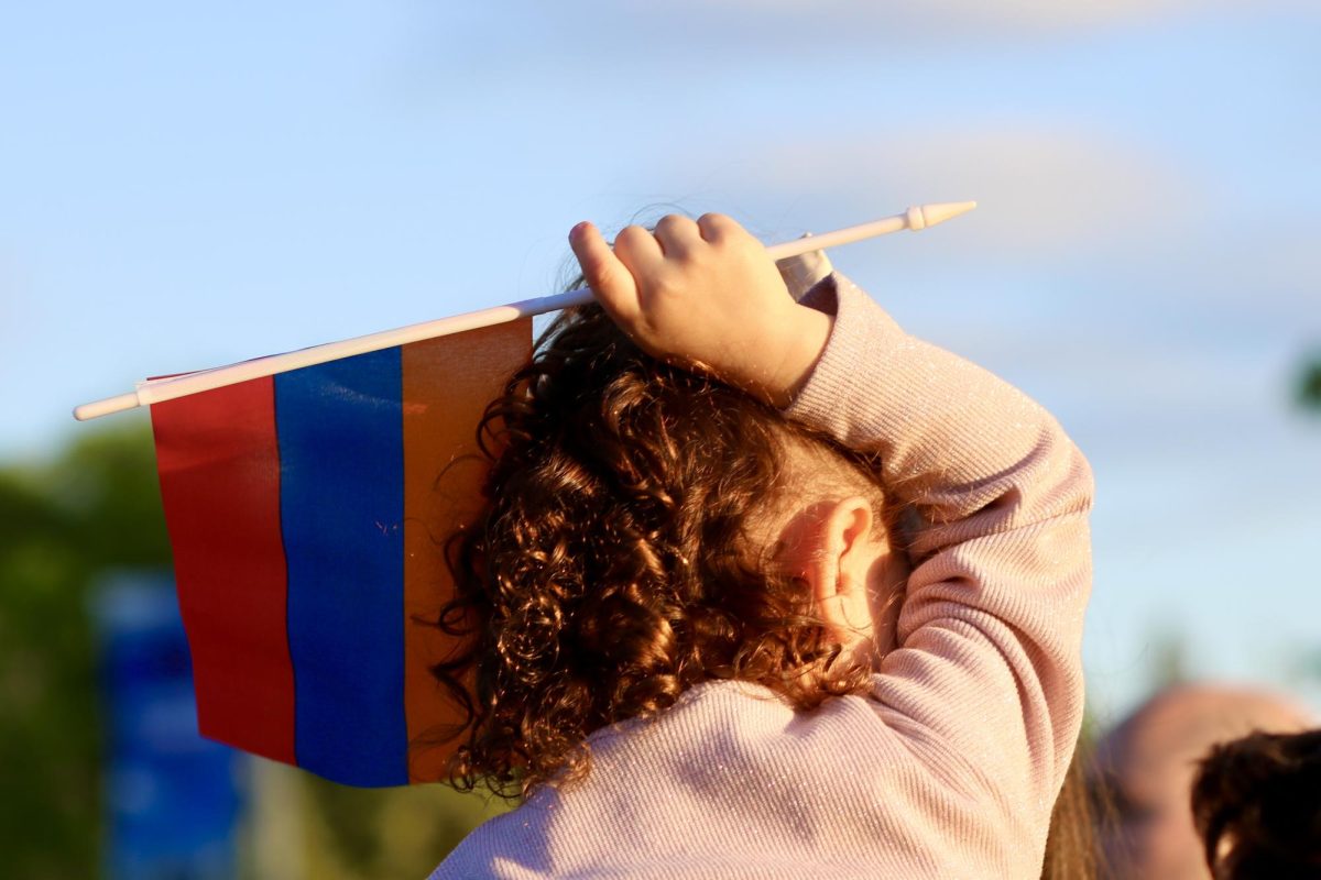 A young girl waves an Armenian flag during the genocide commencement ceremony. 