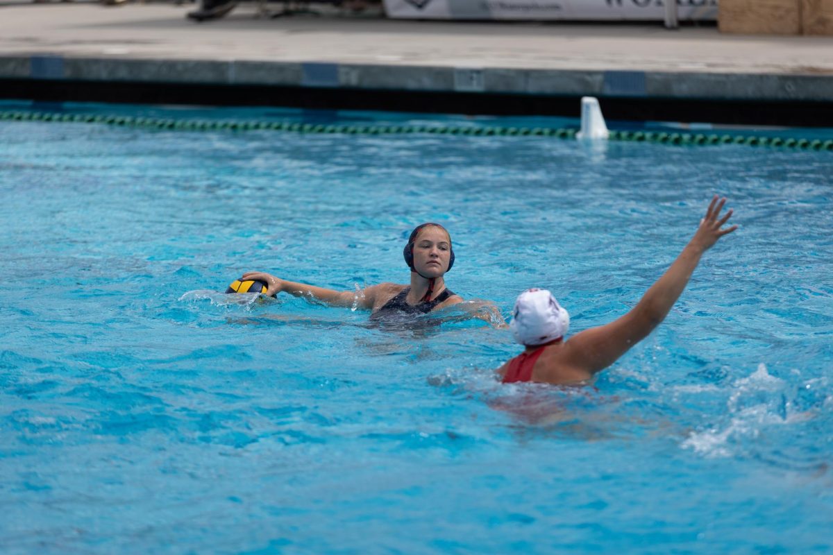 Noa Markovsky looks around while an Aztec defender pressures her.