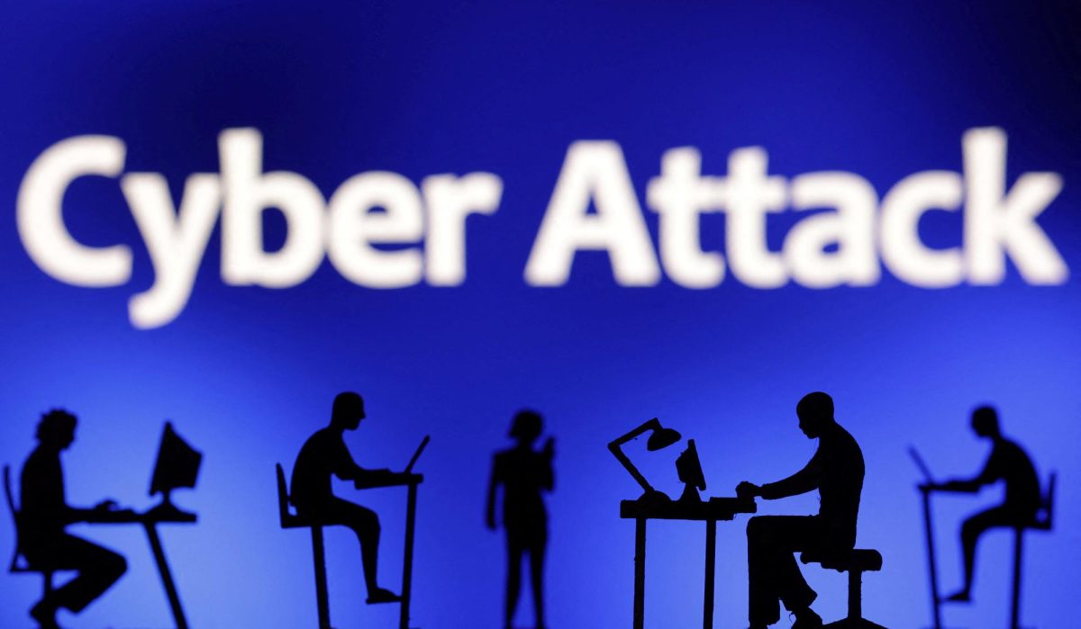 Figurines with computers and smartphones are seen in front of the words "Cyber Attack" in this illustration taken, February 19, 2024. REUTERS/Dado Ruvic/Illustration
