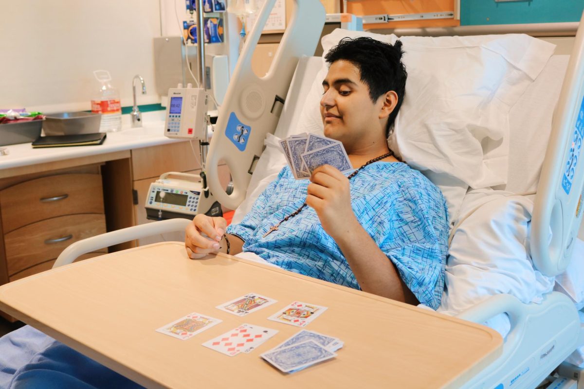 Joshua's personality shining as he poses with his deck of cards. 