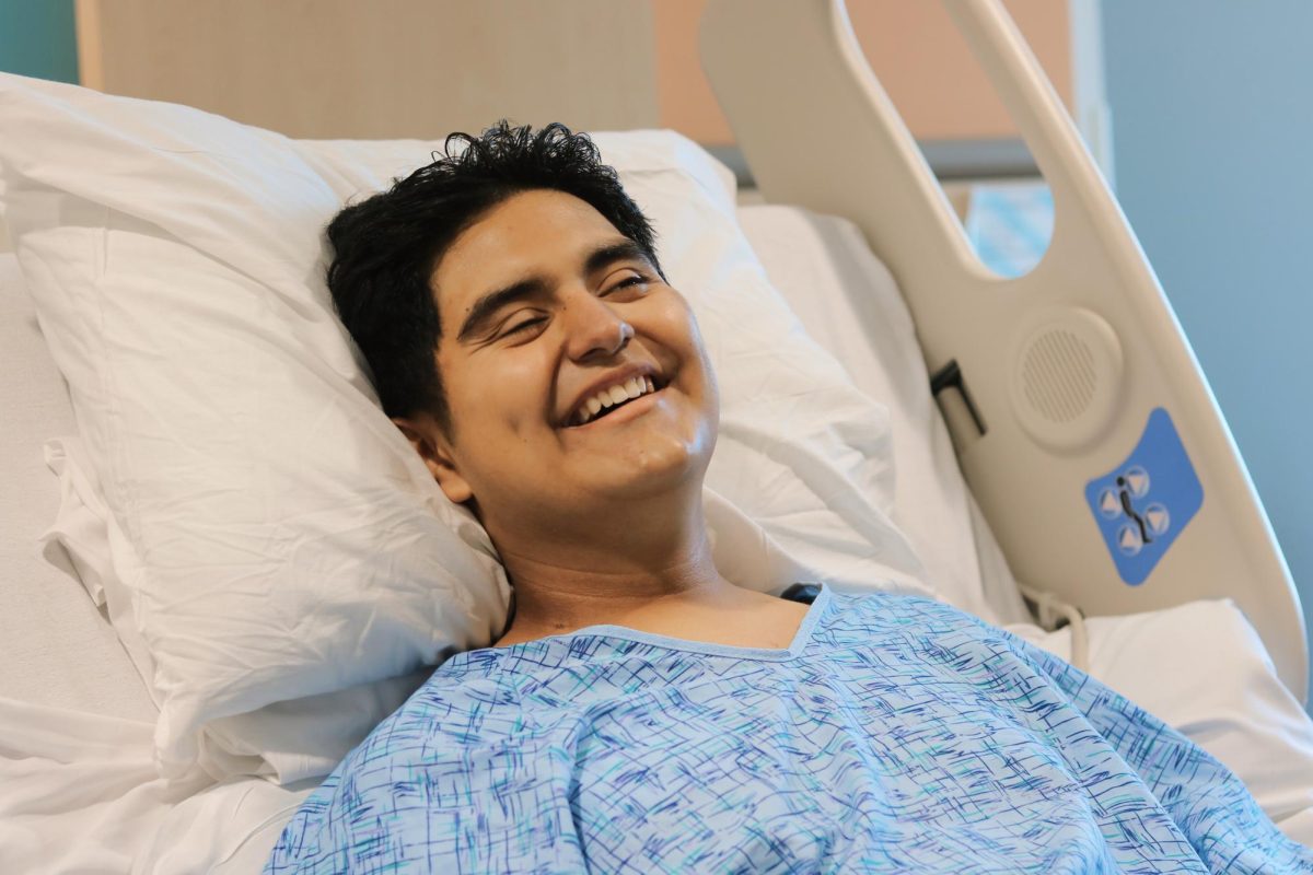 Joshua shares a big smile as he laughs at a joke said to him.  